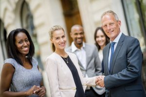Business handshake of a group of people closing a deal